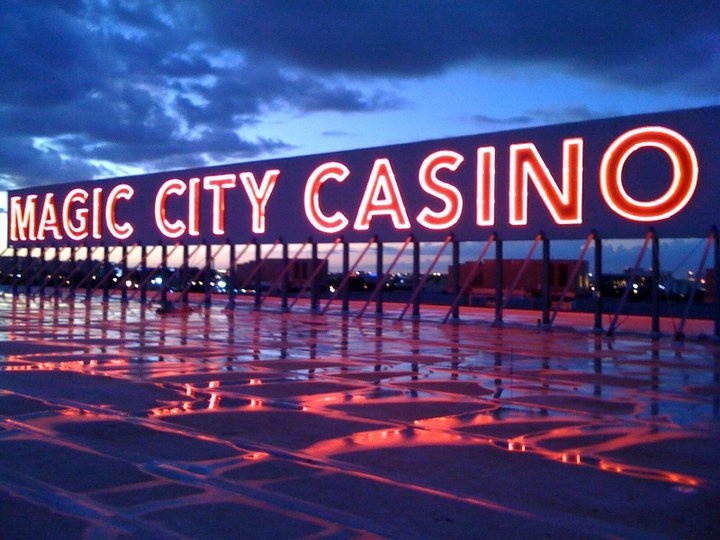 Закат и большие светящиеся буквы Magic City Casino