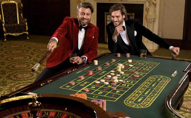Двое обеспеченных молодых мужчин играют в рулетку в вип-зале казино в Тунисе